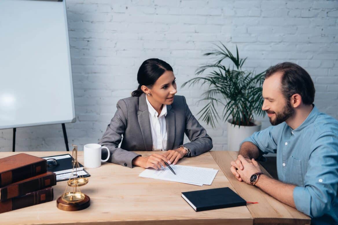 Solicitor And Client Reviewing Documents